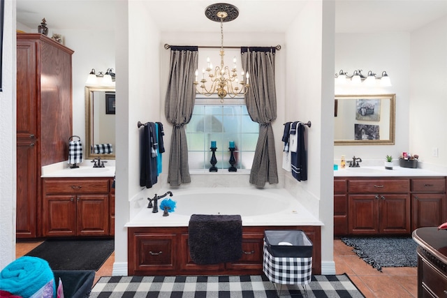 bathroom featuring a chandelier, vanity, tile patterned floors, and a bathtub