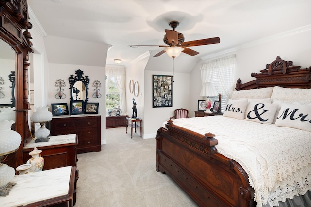 carpeted bedroom featuring ceiling fan, crown molding, and vaulted ceiling