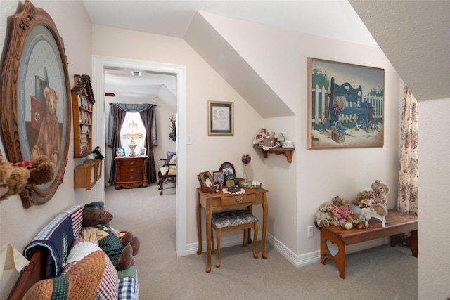 hall with light carpet and lofted ceiling