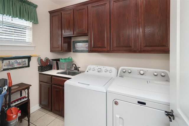 laundry room featuring separate washer and dryer, sink, light tile patterned flooring, and cabinets