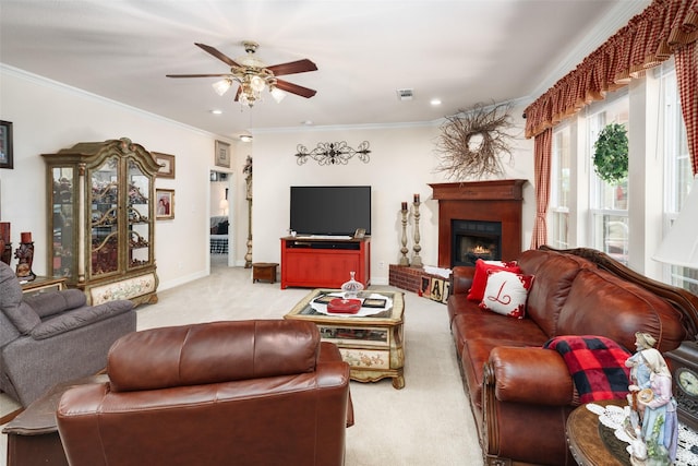 carpeted living room with crown molding and ceiling fan