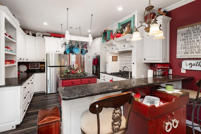 kitchen with pendant lighting, a breakfast bar, stainless steel fridge, dark hardwood / wood-style flooring, and white cabinetry