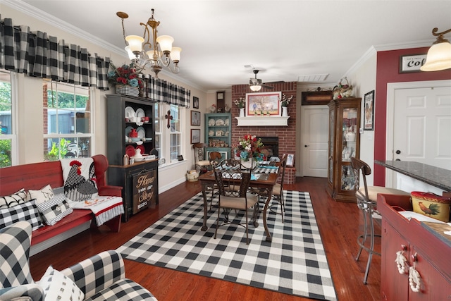 dining room featuring a fireplace, ornamental molding, ceiling fan with notable chandelier, and dark wood-type flooring