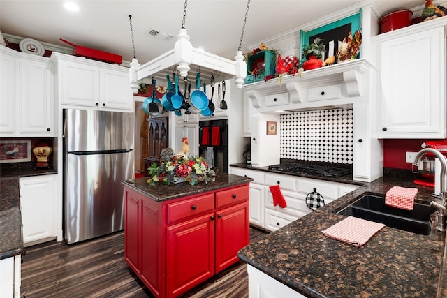 510 N Mcclendon St, Leonard, TX 75452 - kitchen with freestanding refrigerator, black gas stovetop, white cabinets, dark wood finished floors, and ornamental molding