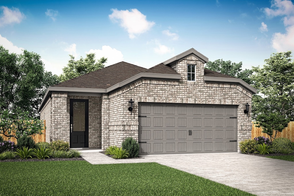 view of front of home with a garage and a front lawn