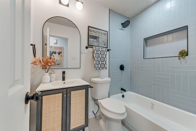 full bathroom featuring vanity, tile patterned flooring, tiled shower / bath, and toilet