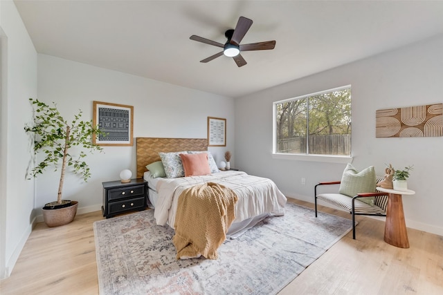 bedroom with light hardwood / wood-style flooring and ceiling fan