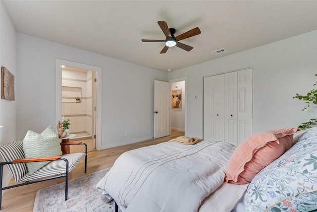 bedroom featuring ceiling fan, light hardwood / wood-style floors, and a closet