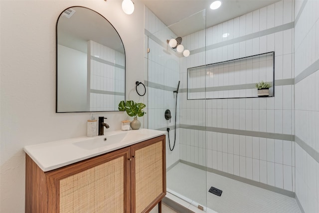 bathroom featuring vanity and a tile shower