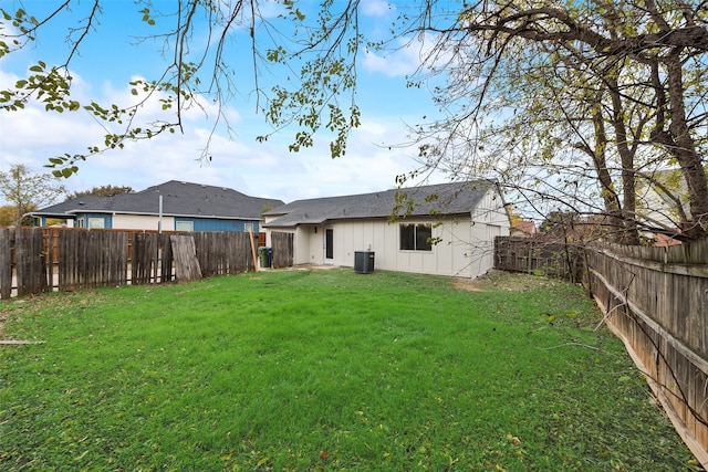 back of property featuring a lawn and central AC unit