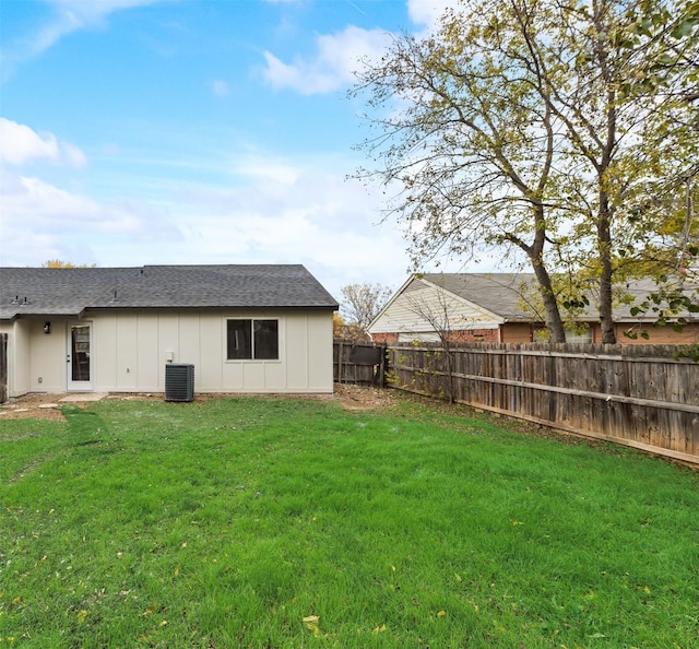 back of property with a lawn and cooling unit