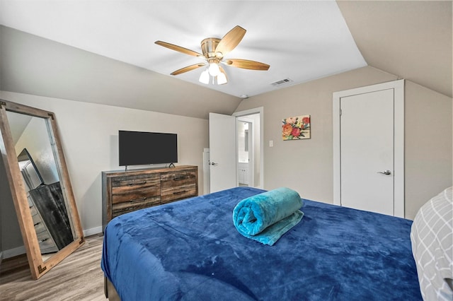 bedroom with ceiling fan, wood-type flooring, and lofted ceiling