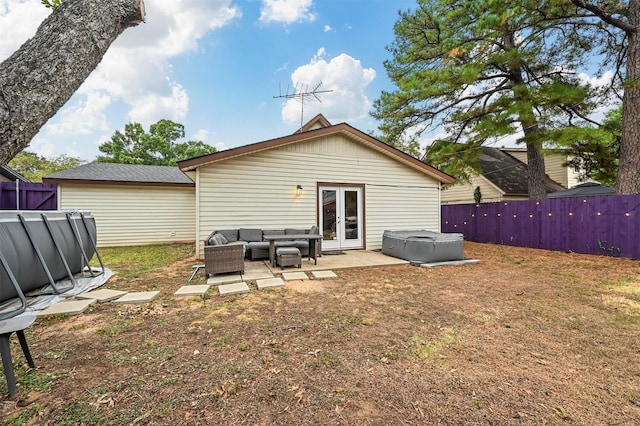 rear view of house with a patio area, outdoor lounge area, and french doors