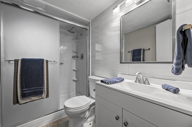 bathroom with walk in shower, vanity, toilet, and a textured ceiling