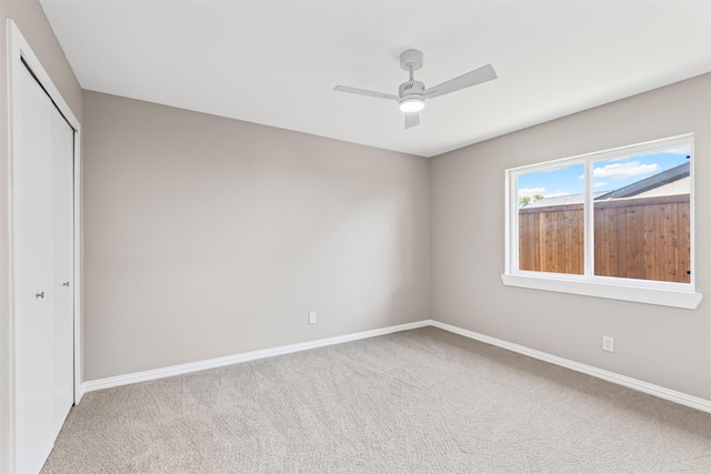 unfurnished bedroom featuring ceiling fan, carpet floors, and a closet