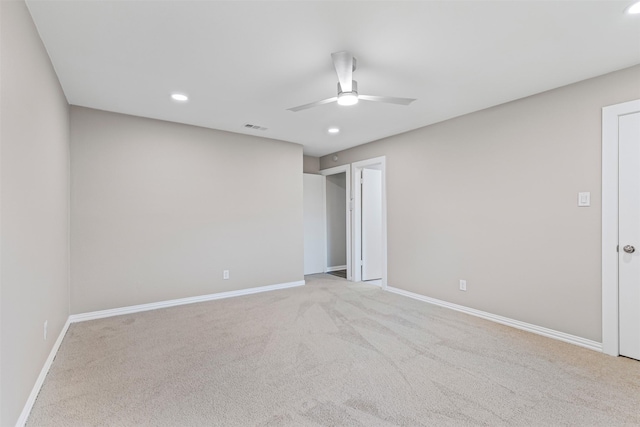 unfurnished room with light carpet and ceiling fan