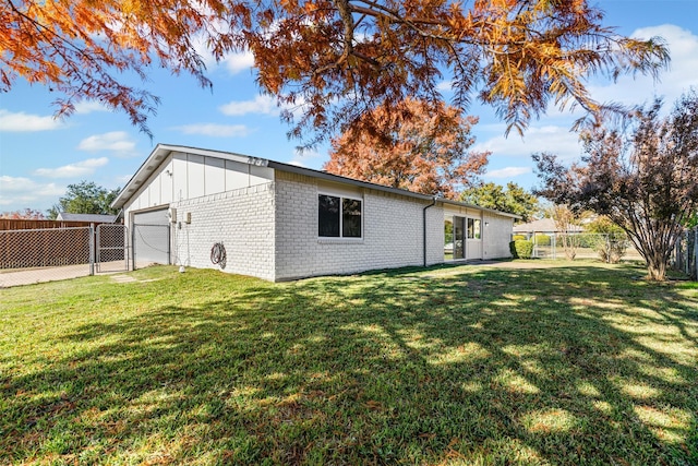 view of side of home with a lawn