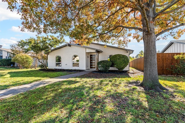 ranch-style house featuring a front lawn