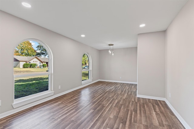 unfurnished room featuring plenty of natural light and hardwood / wood-style floors