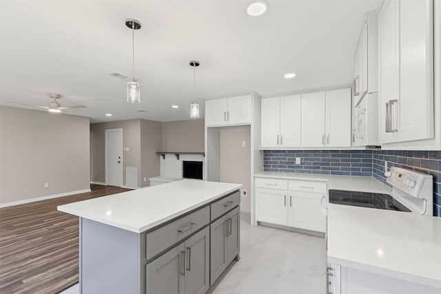 kitchen featuring white cabinets, white appliances, and ceiling fan