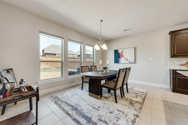 dining space featuring a chandelier and light tile patterned floors