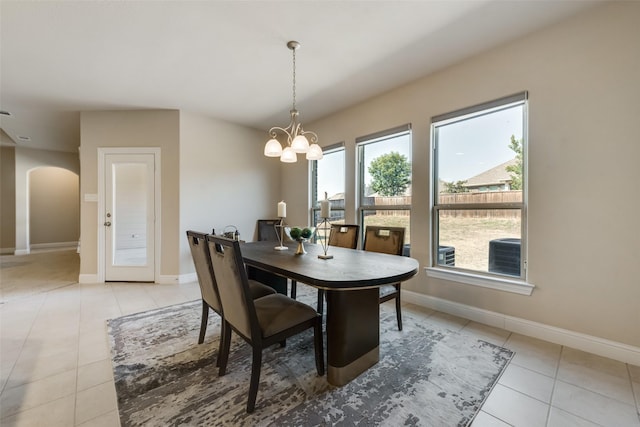 tiled dining space with a chandelier