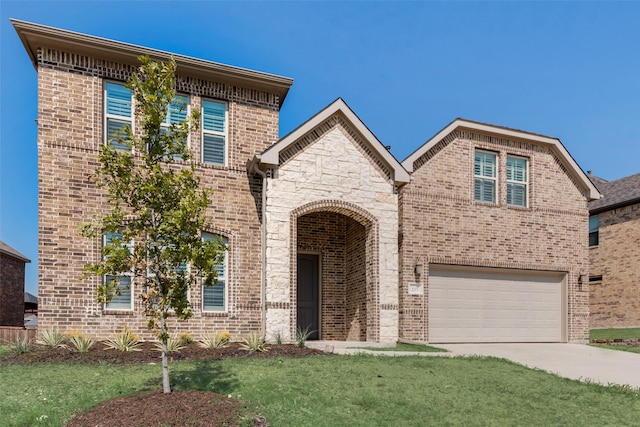 view of front of house with a garage and a front yard