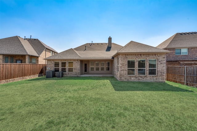 back of property with a patio area, a yard, and cooling unit