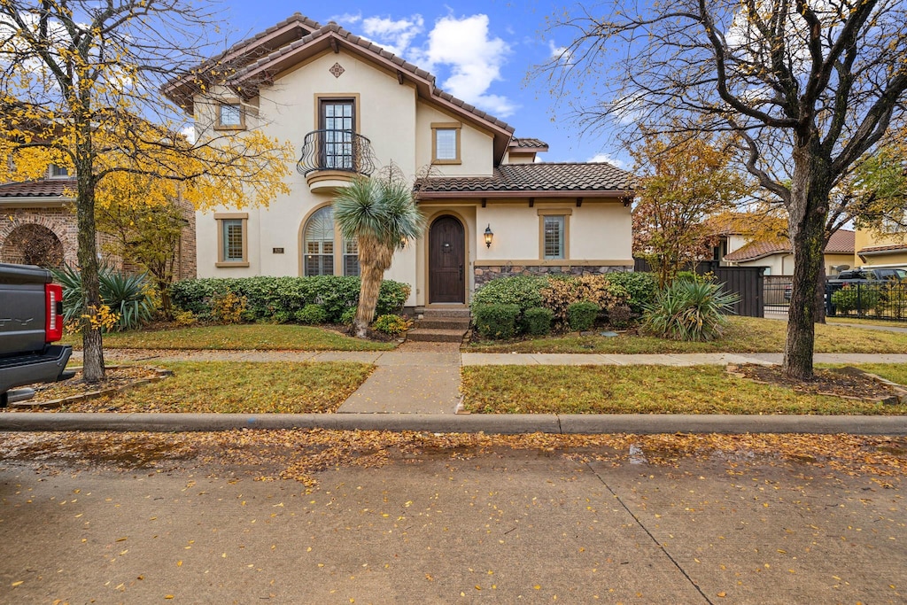 mediterranean / spanish house with a front lawn