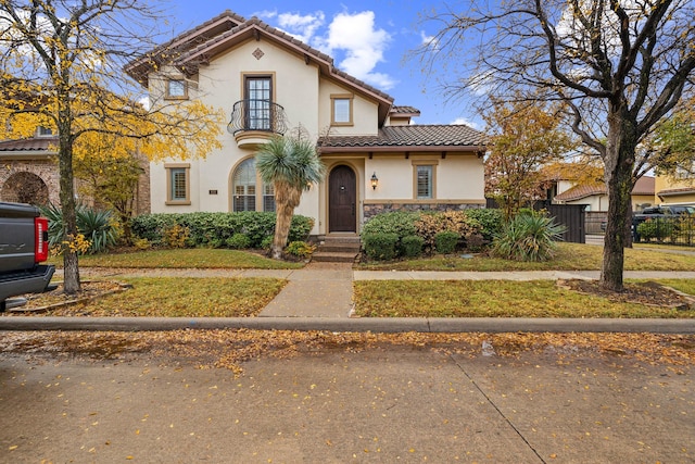 mediterranean / spanish house with a front lawn