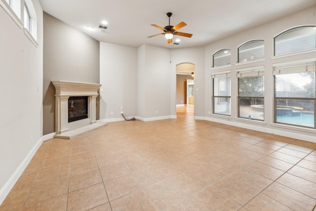 unfurnished living room with ceiling fan and light tile patterned flooring