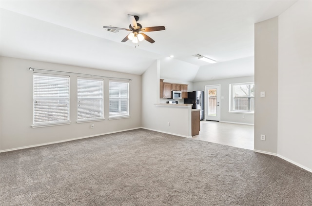 unfurnished living room with light carpet, vaulted ceiling, and ceiling fan