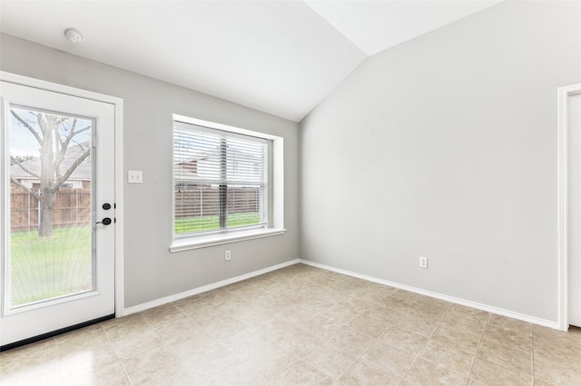 entryway featuring plenty of natural light, lofted ceiling, and light tile patterned floors