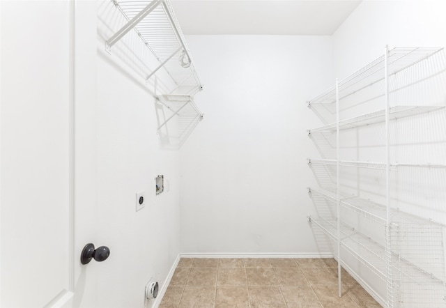 laundry area featuring hookup for a washing machine, electric dryer hookup, and light tile patterned flooring