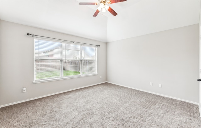 carpeted spare room with ceiling fan and vaulted ceiling