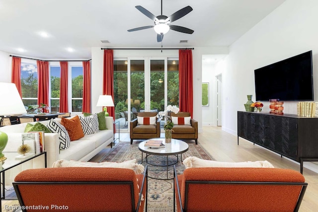 living room with ceiling fan and light wood-type flooring