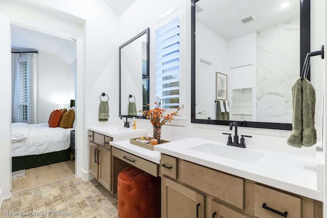 bathroom featuring vanity, vaulted ceiling, and hardwood / wood-style floors