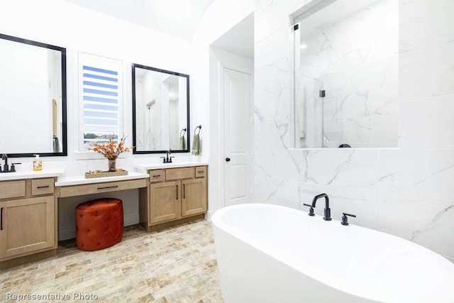 bathroom with vanity, plus walk in shower, and tile walls