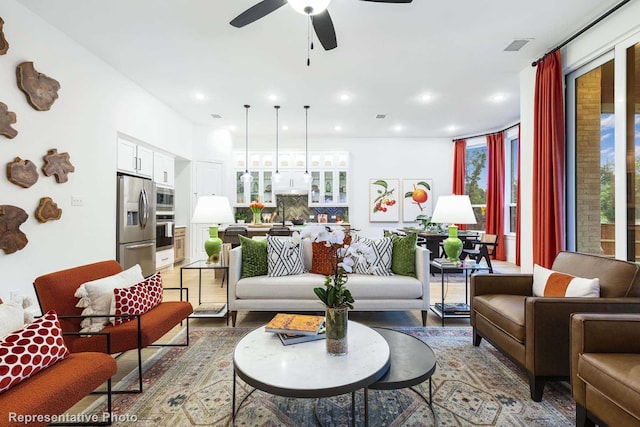 living room with dark hardwood / wood-style flooring and ceiling fan