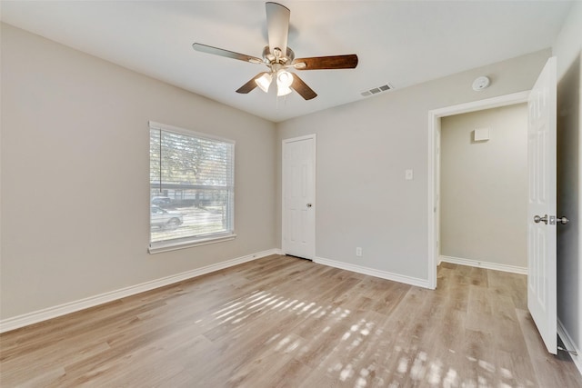 unfurnished room featuring ceiling fan and light wood-type flooring