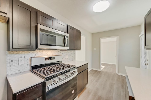 kitchen featuring appliances with stainless steel finishes, light wood-type flooring, tasteful backsplash, and dark brown cabinetry