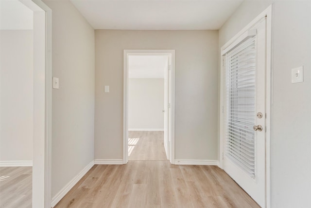 corridor with light hardwood / wood-style floors