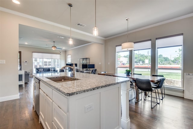 kitchen featuring an island with sink, white cabinetry, ceiling fan, and sink