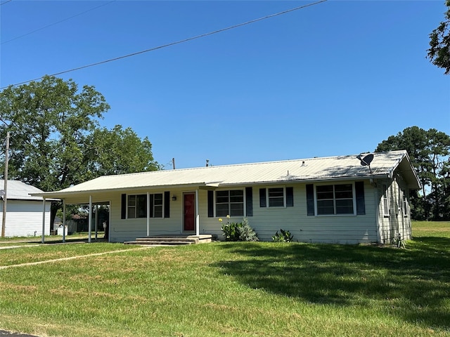 single story home featuring a carport and a front lawn