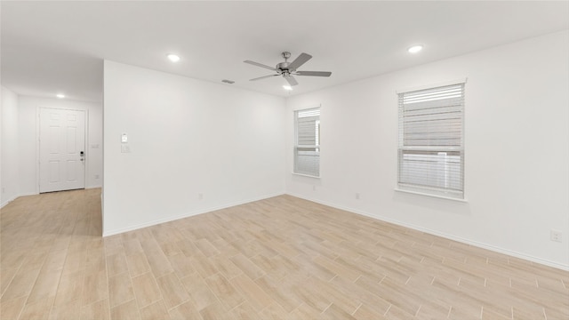 empty room featuring light hardwood / wood-style flooring and ceiling fan