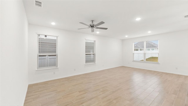 unfurnished room with light wood finished floors, visible vents, and recessed lighting