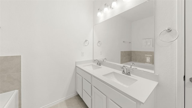 full bathroom featuring baseboards, double vanity, a sink, and tile patterned floors