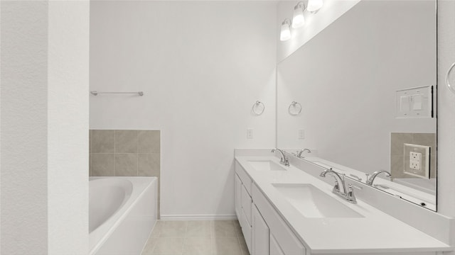 bathroom with double vanity, tile patterned flooring, a washtub, and a sink