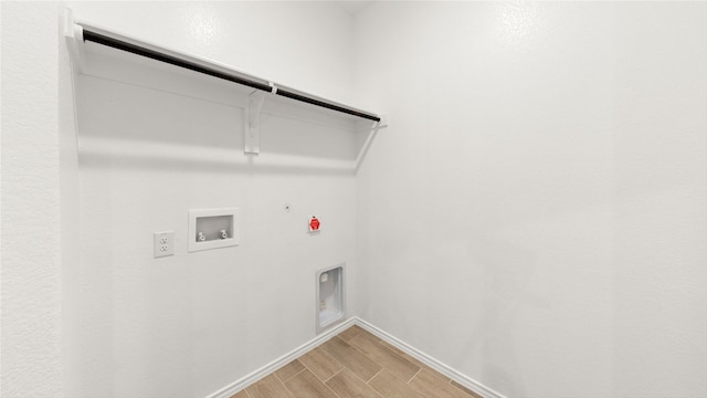 laundry room with hookup for an electric dryer, washer hookup, gas dryer hookup, and wood-type flooring