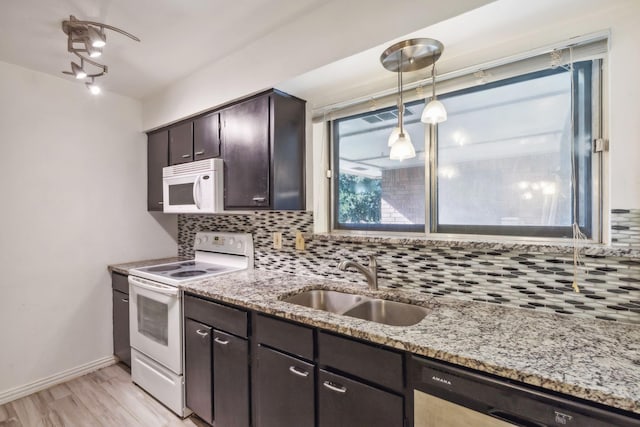 kitchen with white appliances, sink, light hardwood / wood-style flooring, decorative backsplash, and dark brown cabinetry